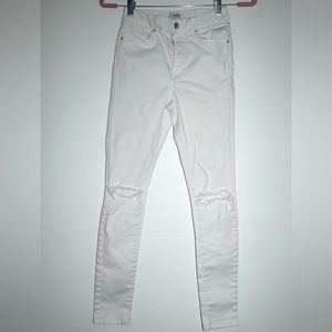 Forever 21 High waisted white jeans with rips in the knees. Stretchy. Size 24.